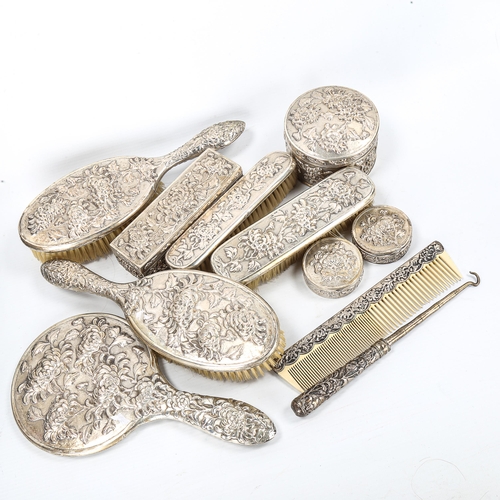 95 - A Chinese export silver 11-piece dressing table set, by Luen Wo circa 1900, relief embossed chrysant... 