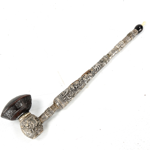 1012 - A Chinese unmarked white metal opium pipe with terracotta bowl, relief decorated dragon decoration, ... 