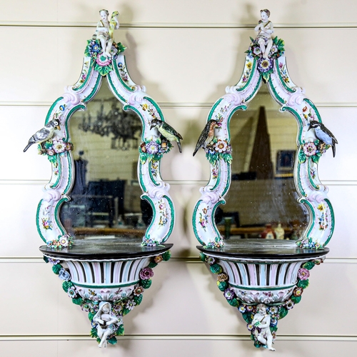 1014 - A large pair of Continental porcelain framed wall brackets, probably late 19th century, with inset s... 