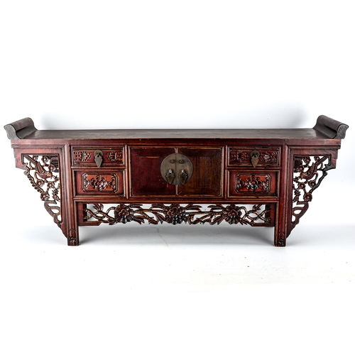 1016 - A Chinese stained wood altar table of small size, with 4 small carved drawers and central cupboard f... 