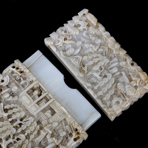 1018 - A Chinese relief carved ivory card case, finely carved designs depicting figures and pagodas, late 1... 