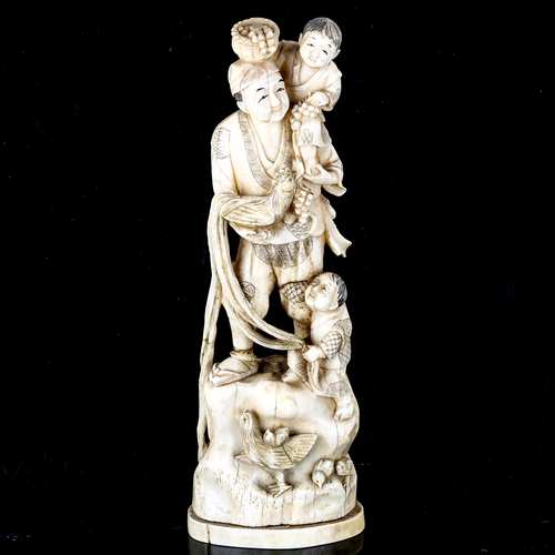 1019 - A Japanese ivory okimono, depicting a farmer with children poultry and baskets of grapes, Meiji Peri... 