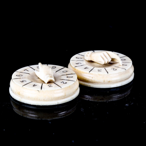 1027 - A pair of 19th century ivory drum-shaped Bridge markers, with hand design mounts, diameter 4.5cm