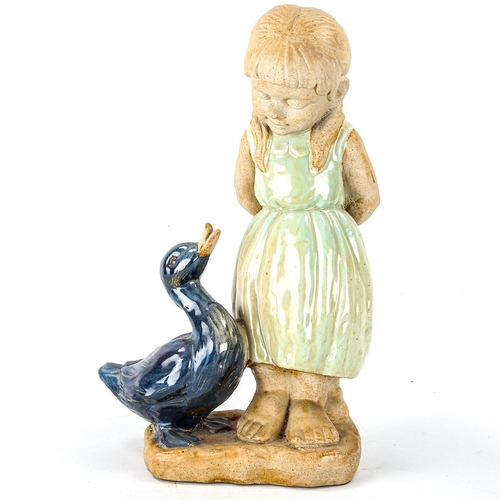 1048 - A partially glazed pottery figure of a girl with duck, no factory marks, height 39cm