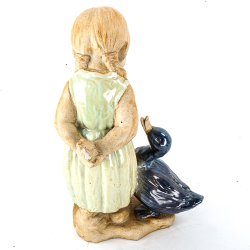 1048 - A partially glazed pottery figure of a girl with duck, no factory marks, height 39cm