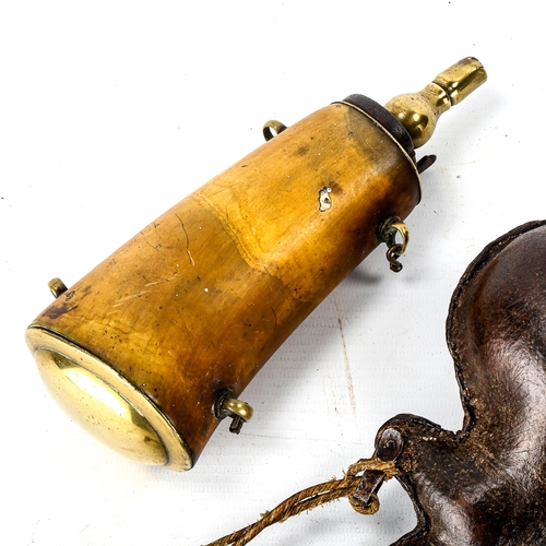 1070 - An Antique buffalo horn powder flask with brass mounts, length 18cm, and a pressed stitched leather ... 