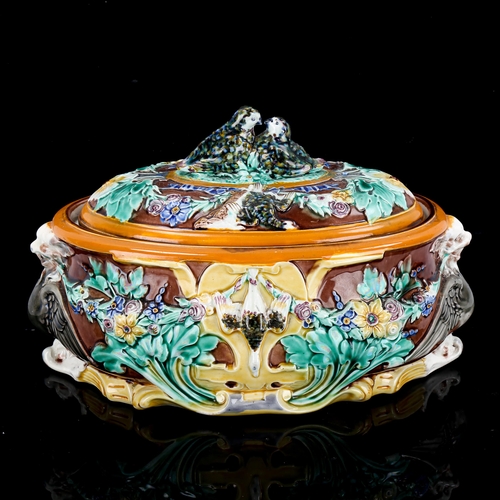 1080 - A Wedgwood Majolica game tureen and cover, with relief moulded game birds and flowers, impressed mar... 