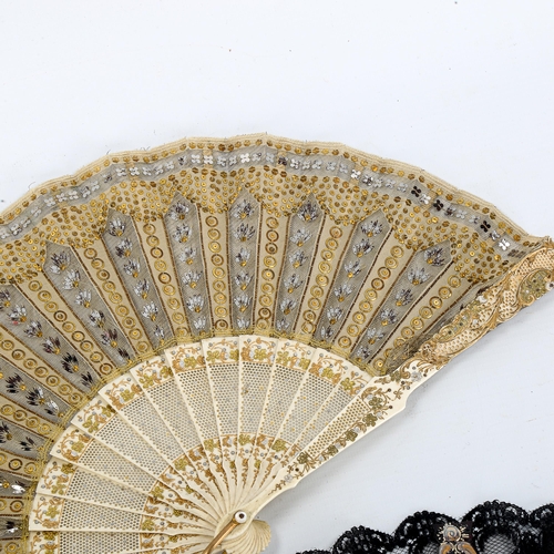 1082 - A 19th century French bone and lace fan, with gilded and pierced sticks, length 21cm, and a simulate... 