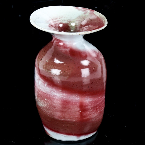 1089 - Marianne de Trey, Studio pottery vase with red marble glaze, height 10cm, rim diameter 6.5cm