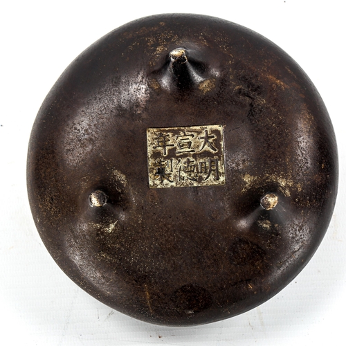 1097 - A Chinese patinated bronze incense burner, impressed seal mark under base, diameter 14cm