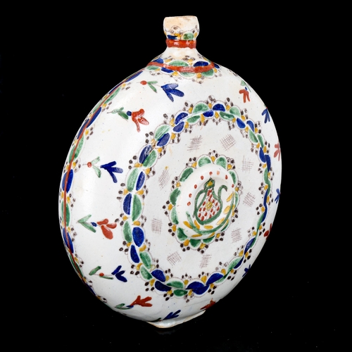 1129 - Turkish Kutahya pottery moon-shaped water flask, with painted decoration, height 20cm