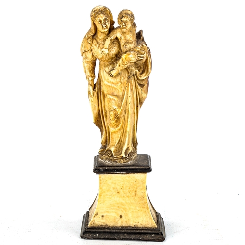 1146 - An Antique carved ivory figure of Mary with the Infant Christ, 18th or 19th century, on ivory plinth... 