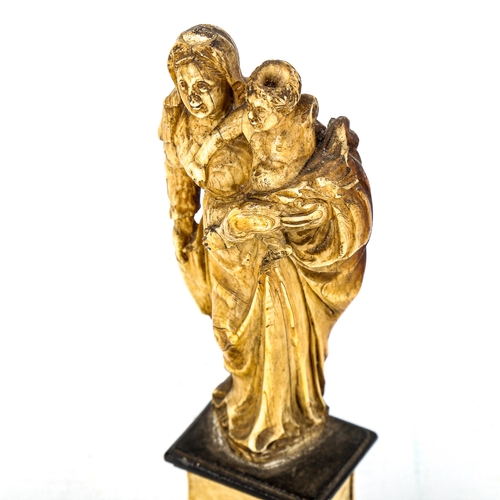 1146 - An Antique carved ivory figure of Mary with the Infant Christ, 18th or 19th century, on ivory plinth... 