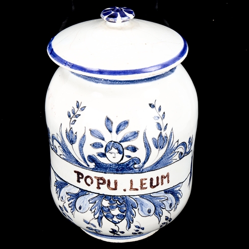 1149 - A Continental tin-glazed faience pottery drug jar and cover, height 13.5cm