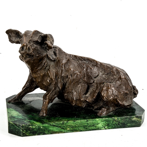 1160 - A patinated Studio bronze sculpture of a pig, indistinctly signed, on green marble base, length 34cm