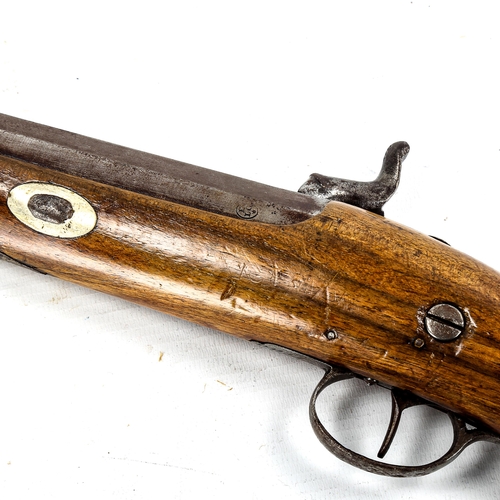 1179 - A 19th century percussion pistol, with engraved lock and carved walnut stock, length 36cm