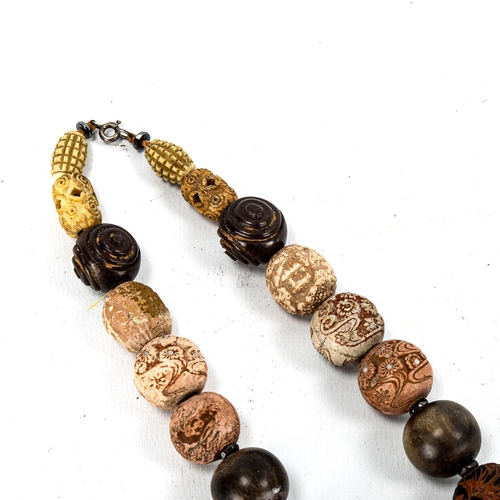 1236 - A string of Chinese beads, including terracotta heads, horn beads, and pierced ivory