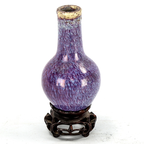 1241 - A Chinese purple glazed narrow-neck vase, on carved wood stand, height 14cm