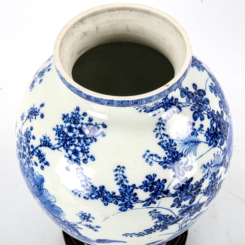 1245 - A Chinese blue and white porcelain vase with painted detailed floral design, attached wood base, hei... 