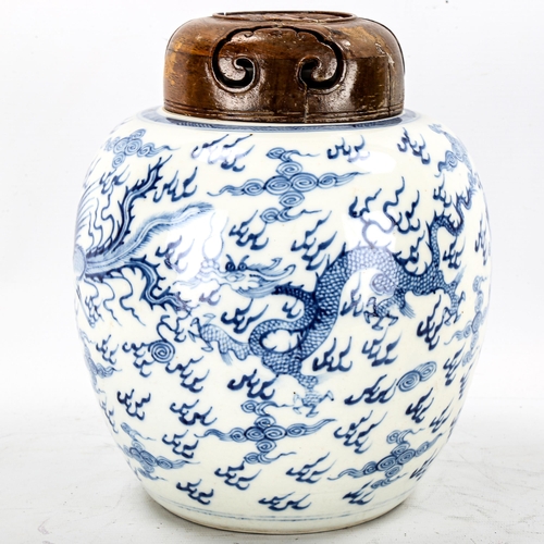 1246 - A Chinese blue and white porcelain dragon jar, with hardwood cover, height 24cm