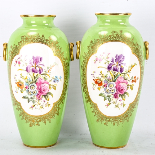 1247 - A pair of Cauldon green ground porcelain vases with hand painted botanical panels, signed B Harrison... 