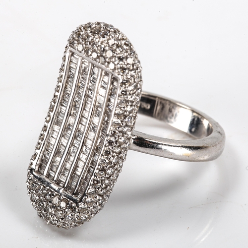 179 - A modern 18ct white gold diamond cluster dress ring, kidney-shaped panel set with modern round brill... 