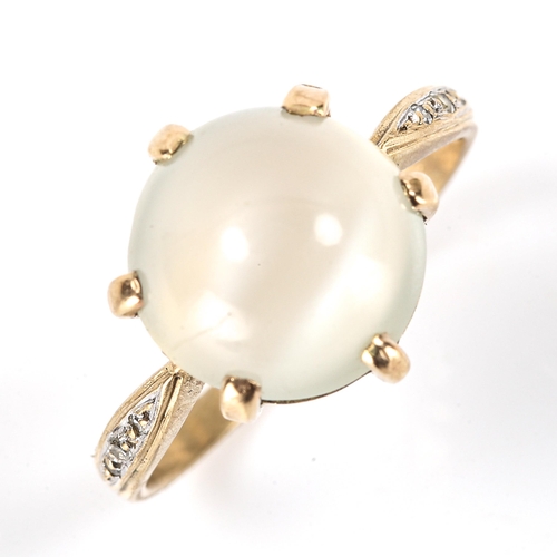 182 - A modern moonstone and diamond dress ring, unmarked gold settings with large round cabochon moonston... 