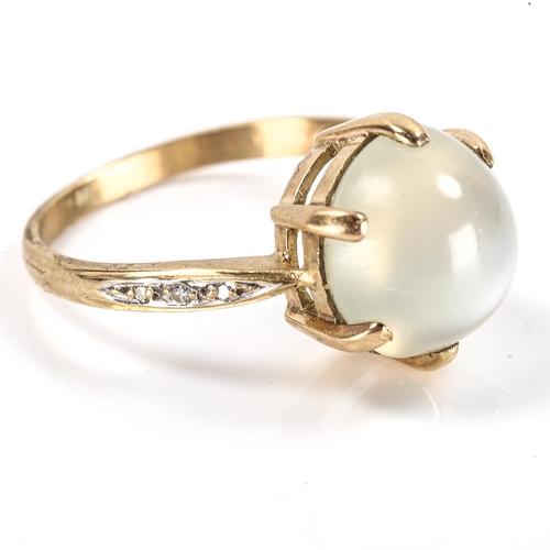 182 - A modern moonstone and diamond dress ring, unmarked gold settings with large round cabochon moonston... 