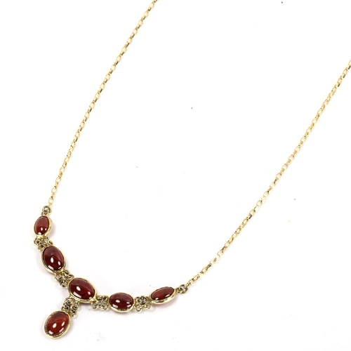 184 - A modern 9ct gold garnet line necklace, set with oval cabochon garnets, necklace length 46cm, 4.6g