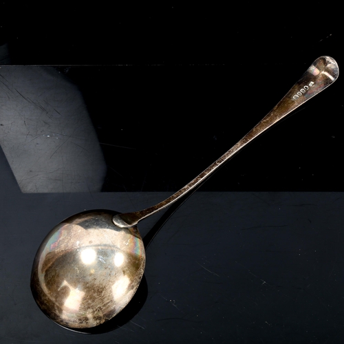 203 - A George III silver Old English pattern soup ladle, bright-cut engraved decoration by Solomon Hougha... 