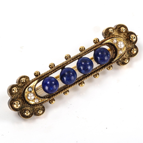 211 - A Victorian lapis lazuli and pearl Etruscan style brooch, unmarked high carat gold openwork settings... 