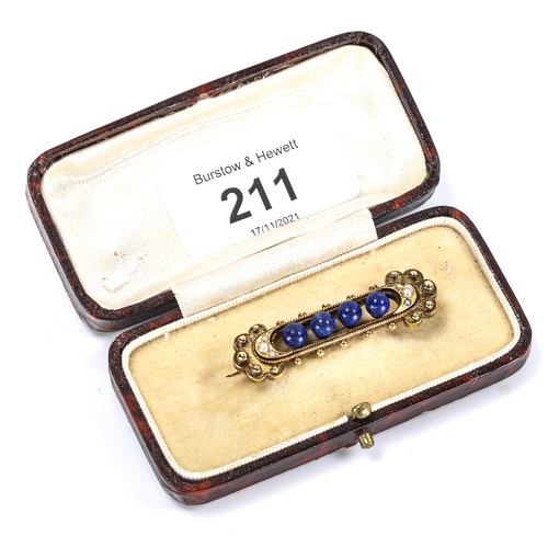 211 - A Victorian lapis lazuli and pearl Etruscan style brooch, unmarked high carat gold openwork settings... 