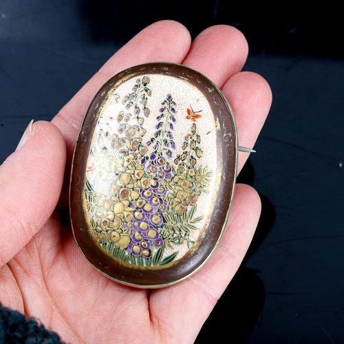 214 - A Japanese Satsuma porcelain panel brooch, hand painted and gilded decoration, with white metal sett... 