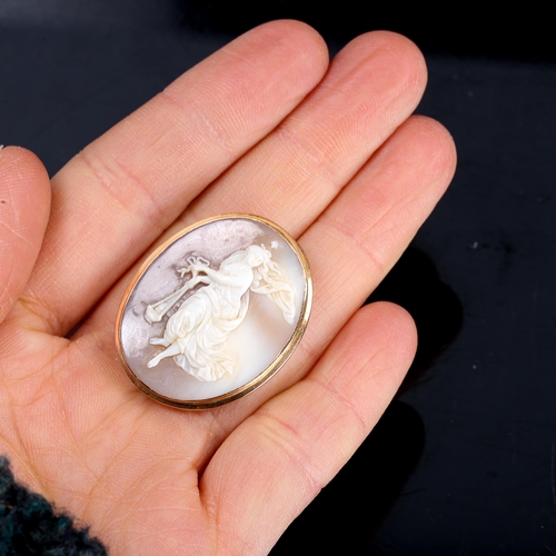 255 - A small relief carved shell cameo brooch, depicting lady with censer, in unmarked yellow metal frame... 