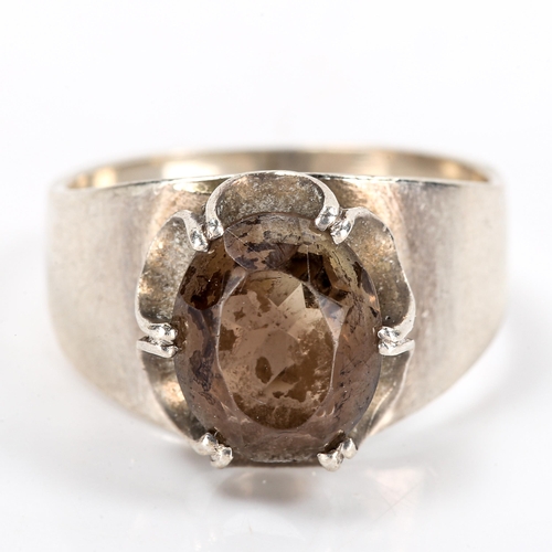 259 - A late 20th century silver smoky quartz ring, claw set with oval mixed-cut quartz, maker's marks W a... 