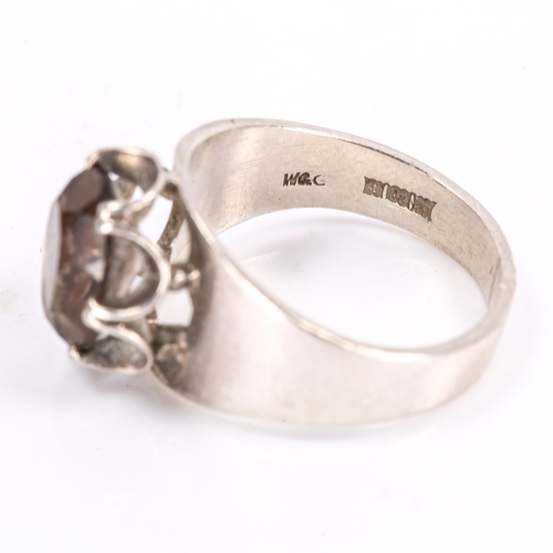 259 - A late 20th century silver smoky quartz ring, claw set with oval mixed-cut quartz, maker's marks W a... 