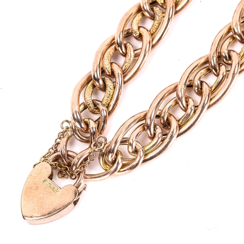 270 - A 9ct gold hollow fancy curb link bracelet, textured and polished settings with heart padlock, brace... 