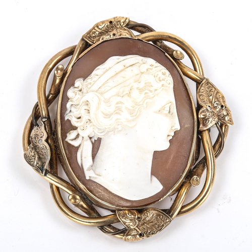 291 - A Victorian shell cameo brooch, depicting female profile, unmarked yellow metal ivy design frame, ov... 