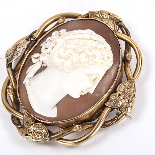 291 - A Victorian shell cameo brooch, depicting female profile, unmarked yellow metal ivy design frame, ov... 