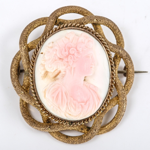 293 - A Victorian carved pink coral cameo brooch, depicting female profile, in unmarked yellow metal textu... 