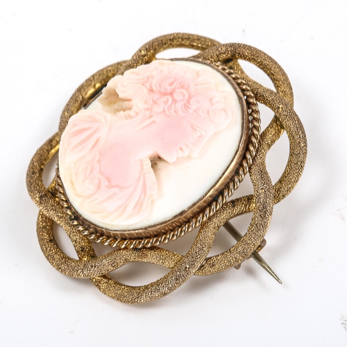 293 - A Victorian carved pink coral cameo brooch, depicting female profile, in unmarked yellow metal textu... 