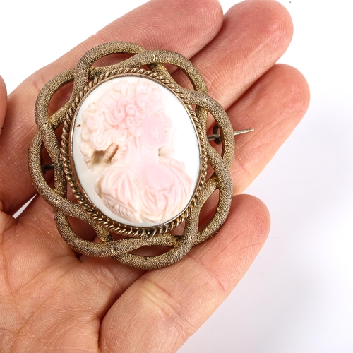 293 - A Victorian carved pink coral cameo brooch, depicting female profile, in unmarked yellow metal textu... 