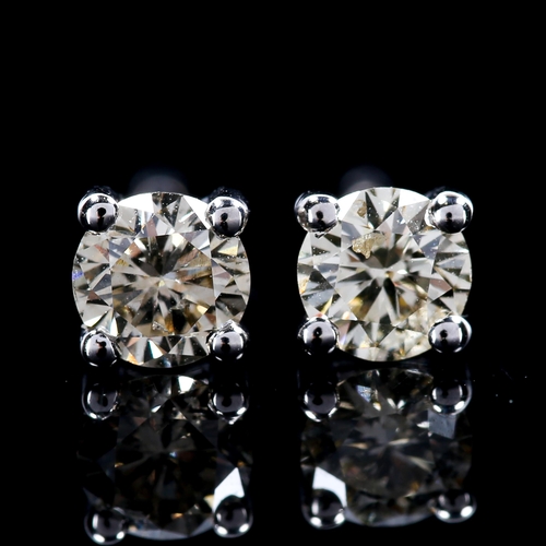 294 - A pair of 0.4ct solitaire diamond stud earrings, unmarked white gold settings with modern round bril... 