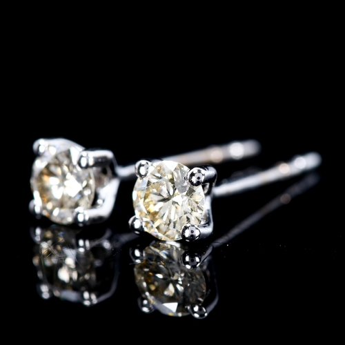 294 - A pair of 0.4ct solitaire diamond stud earrings, unmarked white gold settings with modern round bril... 