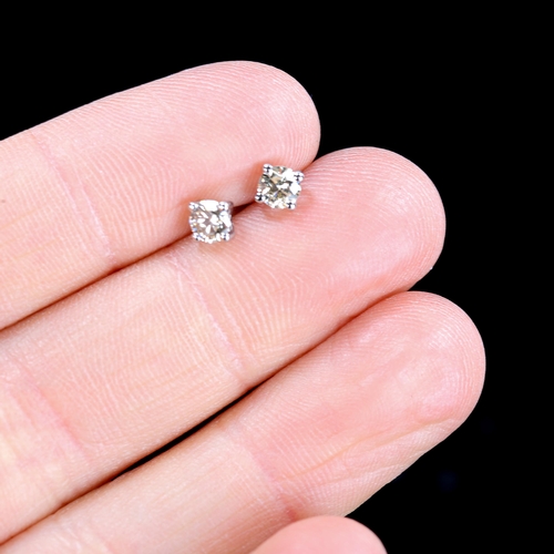 294 - A pair of 0.4ct solitaire diamond stud earrings, unmarked white gold settings with modern round bril... 