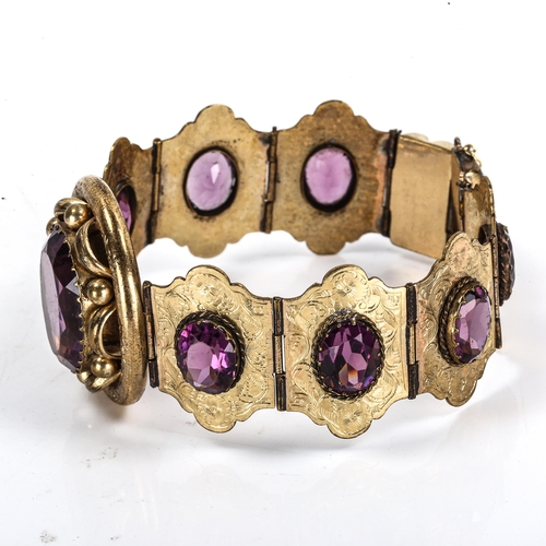 295 - A Victorian gilt-metal amethyst panel bracelet, set with oval mixed-cut amethysts with engraved flor... 