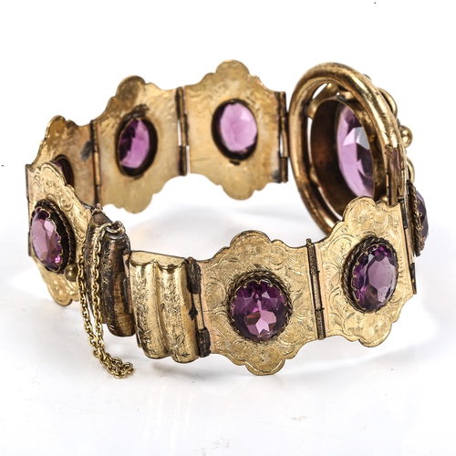 295 - A Victorian gilt-metal amethyst panel bracelet, set with oval mixed-cut amethysts with engraved flor... 