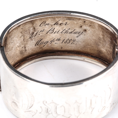 298 - A Victorian unmarked silver hinged cuff bangle, engraved leaf decoration with inscription dated 1882... 