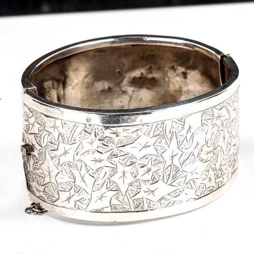 298 - A Victorian unmarked silver hinged cuff bangle, engraved leaf decoration with inscription dated 1882... 