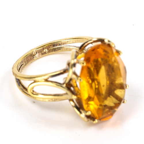 306 - A late 20th century citrine dress ring, unmarked yellow metal openwork settings, citrine length 18mm... 